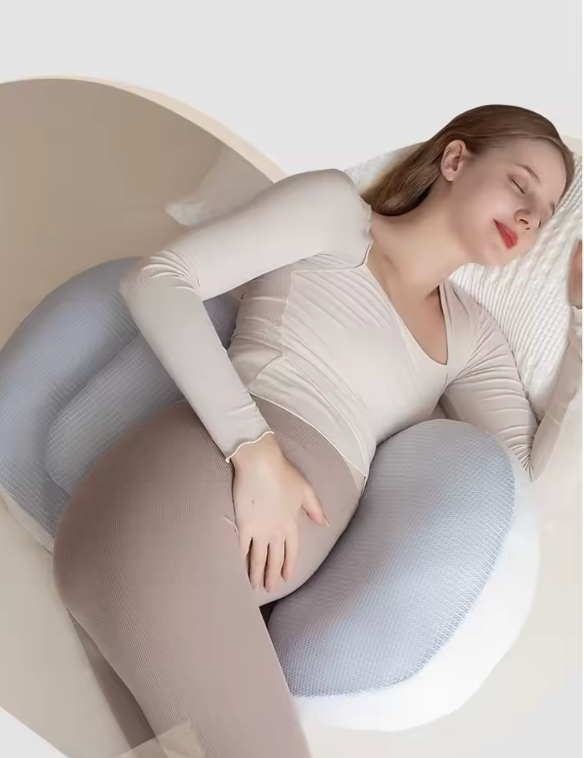 Femme enceinte dormant paisiblement avec un coussin de grossesse Be'Link gris clair signé BEBLY, offrant un maintien optimal du dos et du ventre.
